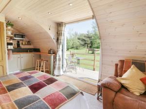a bedroom with a bed and a kitchen with a balcony at Idris Pod in Tremeirchion