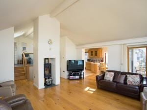 a living room with a couch and a television at Totherside in Dartmouth