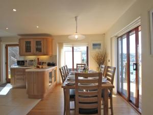 a kitchen with a table and chairs in a room at Totherside in Dartmouth +17 photos