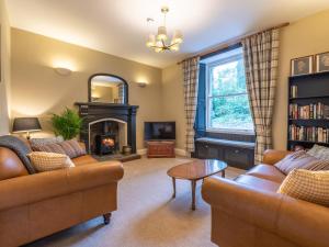 a living room with two couches and a fireplace at Magistrates Chambers in Ingleton 