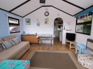 a living room with a couch and a table at Captain's Cabin in Aberystwyth