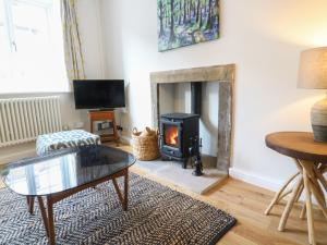a living room with a wood burning stove at Evergreen in Ilkley