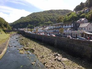 a river in a town with houses and buildings at Old Lyn Cottage in Lynmouth