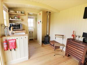 a room with a kitchen with a stove at Ryan's Rest in Bowness-on-Solway