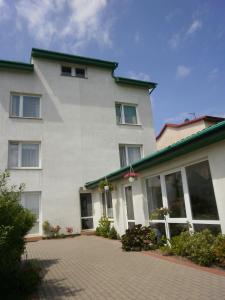 a large white building with a lot of windows at APARTAMENT i pokoje Aura Dom Wczasowy in Darlowko