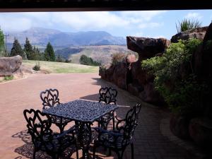 - une table et des chaises sur une terrasse avec vue dans l'établissement The Bunker, à Champagne Valley