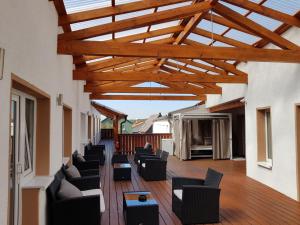 a living room with couches and chairs on a deck at Gaststätte und Hotel zur Krone in Pohlheim +6 photos