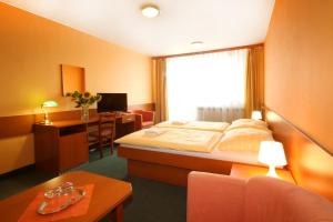 Posteľ alebo postele v izbe v ubytovaní Hotel Strážnice
