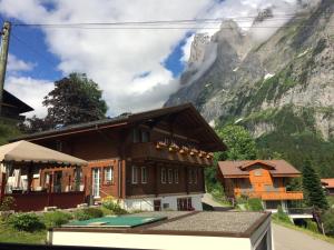 a building with a mountain in the background at Chalet Verbrunnenhaus Grindelwald in Grindelwald