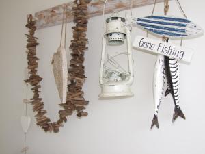 a sign that says gone fishing hanging on a wall at Lulworth Cove Inn in Lulworth Cove