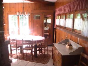 un comedor con mesa y sillas en una casa en Gîte de la baerenbach, en Hazelbourg