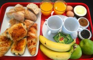 a tray of food with breakfast foods and drinks at Aux Tourelles 1888 - Tres Proche Lyon #Clim #Piscine #Netflix #Parking Payant Securise in Tassin-la-Demi-Lune