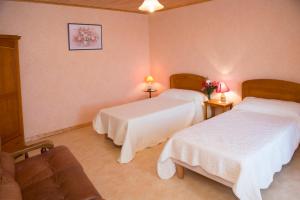 a hotel room with two beds and a couch at gites de la Vaysse in Vergt-de-Biron