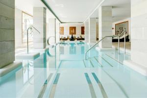 a swimming pool in a house with glass floors at Grupotel Los Príncipes & Spa in Playa de Muro