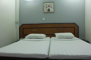 two beds sitting next to each other in a bedroom at The Park House in Male City