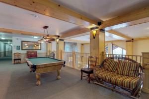 a room with a pool table and a couch at Copper Springs in Copper Mountain