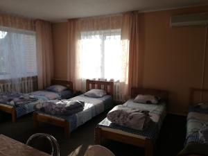 a room with three beds and a window at Pasile in Kaunas