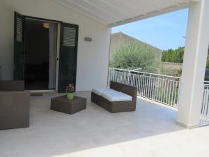 a patio with a bench and a balcony at casa verdemare in Cefalù