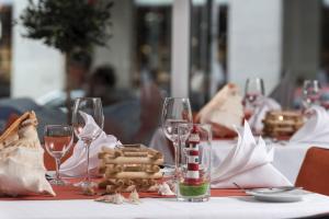 a table with wine glasses and food on it at Maritim proArte Hotel Berlin in Berlin