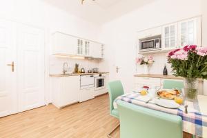 a kitchen with a table with a plate of food on it at Prague Siesta Apartments in Prague