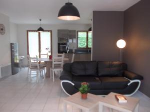 a living room with a couch and a table at Gite Du Moulin Du Vivier in Seigy