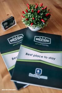 a bunch of boxes with a plant on a table at Brickyard Apartments Cluj in Cluj-Napoca