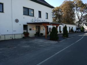 a white building with an entrance to a street at landgasthof-zur erholung in Schkeuditz