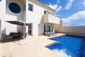 a villa with a swimming pool and a house at Tabaiba Luxus Chalet with heatable pool in El Rosario