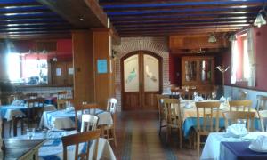 a dining room with tables and chairs in it at Hotel Puerta Sepúlveda by Bossh Hotels in Sepúlveda
