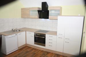 a kitchen with white cabinets and a sink at Ferienwohnung Golden Lotus in Neuwied +7 photos