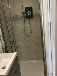 a bathroom with a shower with a toilet and a sink at Kiki’s Corner in Newquay +12 photos