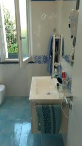 een badkamer met een wastafel en een spiegel bij MARGIE'S HOUSE in Procida