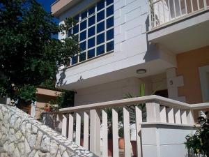 a white fence in front of a house at Apartments Jani in Hvar