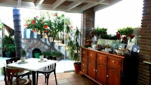 
a living room filled with furniture and flowers at Welcome Inn Nerja guest house Luxury Bed & Breakfast in Nerja
