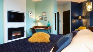 a bedroom with a bed and a fireplace at Logis Hôtel La Chaize in Noirmoutier-en-l'lle