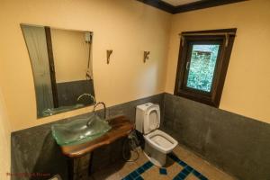 a bathroom with a sink and a toilet at Baan Khaosok Resort in Khao Sok