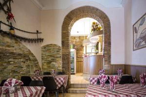 a dining room with tables and chairs and an archway at Hotel Castelfidardo in Rome