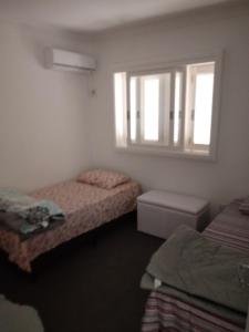 Ένα ή περισσότερα κρεβάτια σε δωμάτιο στο CASA JE - Santa Cruz do Sul