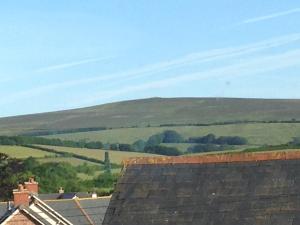 a view of the hills from the roof of a house at Exmoor House in Wheddon Cross