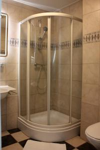 a shower stall in a bathroom with a toilet at Hotel De Hoefpoort in Gemert