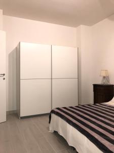 a bedroom with a bed and a large white closet at Bari Lory’s Home in Bari