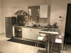 a kitchen with a sink and a stove top oven at Bari Lory’s Home in Bari