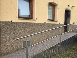 a building with a stair railing next to a building at Saarlogis Haus Ferienwohnungen St Arnual in Saarbrücken