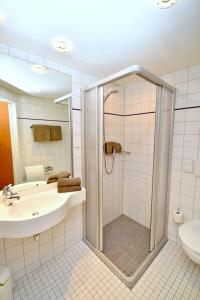 uma casa de banho com um chuveiro, um lavatório e um WC. em Hotel & Restaurant Zum Deutschen Hause em Kirchhatten