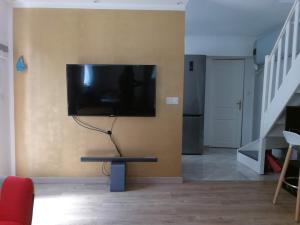 a living room with a flat screen tv on a wall at Résidence Hélène Boucher in Villeneuve-Saint-Georges