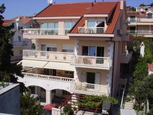 an apartment building with balconies and a red roof at Apartments Jani in Hvar