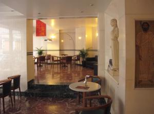 a restaurant with a table and chairs in a room at Evripides Hotel in Athens