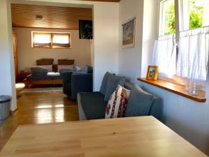 a living room with blue chairs and a table at Schwarzwaldmädel in Sankt Peter