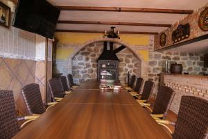 a long table in a room with a fireplace at La Garrocha in Colmenar del Arroyo +54 photos