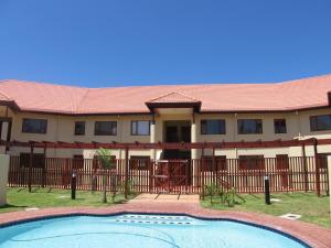 a house with a swimming pool in front of it at Kuta Beach A in Ramsgate